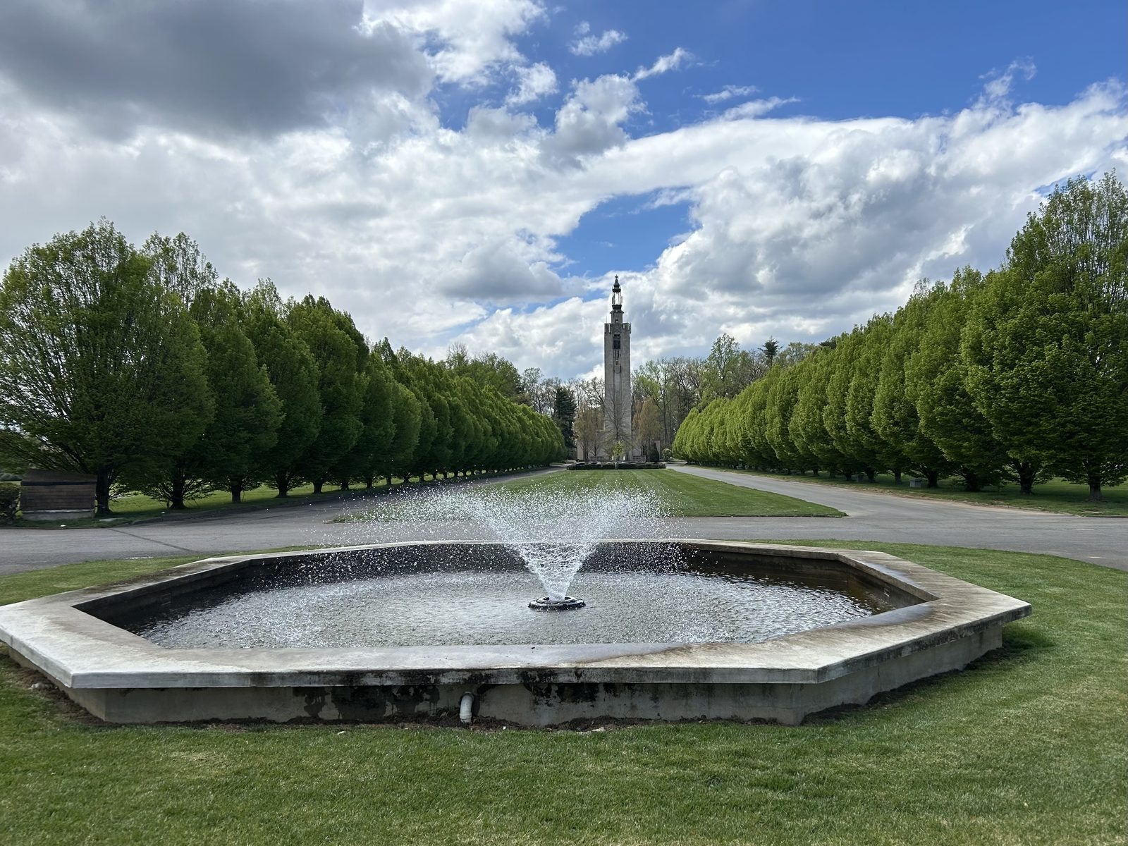 Tree-lined avenue and fountain leading to the tower at White Marsh Memorial Park
